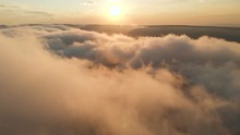 Flying Through The Clouds At Dusk Or Dawn. Flying In Pink Clouds In The Sun. Aerial View. North Caucasus