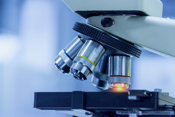 Wall Mural - close-up shot of microscope equipment with metal lens at microbiologal laboratory