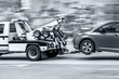 tow truck delivers the damaged vehicle  in monochrome blue tonality