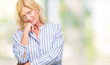 © Krakenimages.com - Middle age blonde business woman over isolated background thinking looking tired and bored with depression problems with crossed arms.