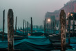 Winter morning in Venice Italy, iconic gondola boats, surreal foggy dramatic photo