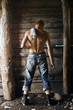 back of a handsome man in a rustic barn