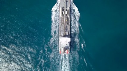 Wall Mural - Large crude oil tanker roaring across The Mediterranean sea - Aerial footage following the ship