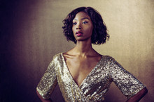 Portrait Of A Beautiful Woman In Golden Sequin Dress Waiting For Her Dreams