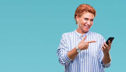 Sticker - Atrractive senior caucasian redhead woman texting using smartphone over isolated background very happy pointing with hand and finger