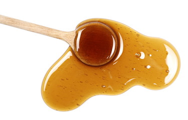 honey with wooden spoon isolated on white background, top view
