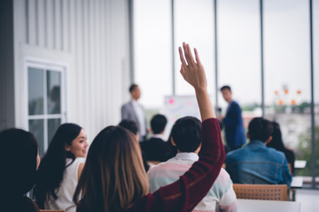 woman raised up hands and arms in seminar class room to agree with speaker at conference seminar mee