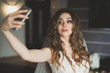 © olegparylyak - Beautiful bride making selfie in the home before wedding