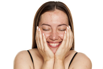 beautiful middle-aged smiling woman without makeup lying on her hands on white background