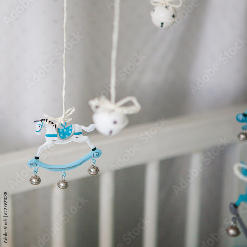 toys hanging above cot