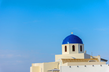 Wall Mural - Santorini, Greece. Picturesque view of traditional Cycladic Oia Santorini's church on cliff