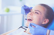 © lenets_tan - Young Female patient with open mouth examining dental inspection at dentist office.