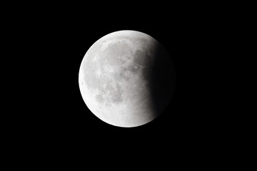 Wall Mural - super bloody moon, full eclipse last phase against black sky background, quarter of the moon surface