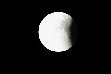 Wall Mural - super bloody moon, full eclipse last phase against black sky background, quarter of the moon surface