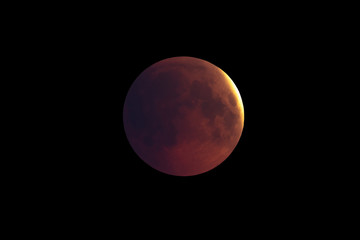 Wall Mural - super bloody moon, first phase of full eclipse against black sky background
