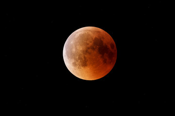 Wall Mural - super bloody moon, beginning of full eclipse end phase against starry sky background