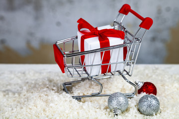 Christmas gift in a shopping cart