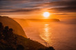 Orange glow sunrise at coastline cliff