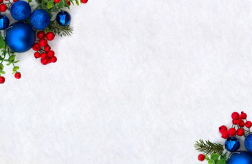 christmas decoration. frame of twigs christmas tree, christmas blue balls and red berries on snow wi