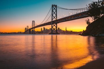 Fototapete - San Francisco skyline with Oakland Bay Bridge at sunset, California, USA