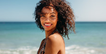 Portrait Of A Curly Haired Woman At The Beach