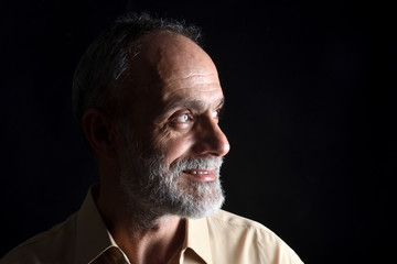 Wall Mural - portrait of middle aged man on black