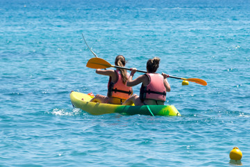 two girls go out to sea on a kayak