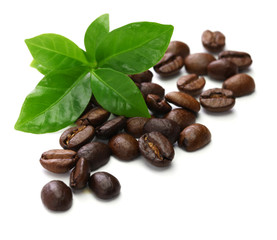 Wall Mural - scattered roasted coffee beans and leaves on white  background
