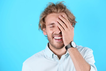 Sticker - Handsome young man laughing on color background