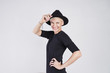 © olgapogorelova - Portrait of blonde caucasian woman wearing black clothes and hat smilling and posing on white background.