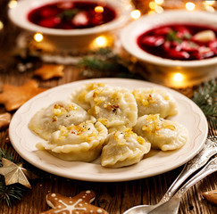 Wall Mural - Christmas dumplings stuffed with mushroom and cabbage on a white plate. Traditional Christmas eve dish in Poland