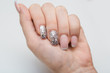 © honcharr - Beautiful groomed woman's hands with white nails on the light gray background. Nail varnishing in white color. Manicure, pedicure beauty salon concept. Empty place for text or logo.