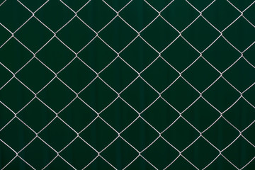  Metal grid on dark green background
