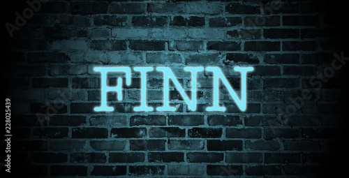 Photographie first name Finn in blue neon on brick wall