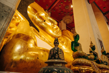 Old golden reclining buddha at Wat Phra Non Chakkrasi Worawihan, Singburi Province, Thailand.