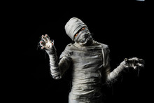Studio Shot Portrait  Of Young Man In Costume  Dressed As A Halloween  Cosplay Of Scary Mummy Pose Like A Clamber Acting On Isolated Black Background
