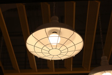 A electric lamp lighting . modern and vintage style , interior ceiling hanging light bulb decorate at room