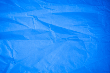 Crumpled blue paper background.