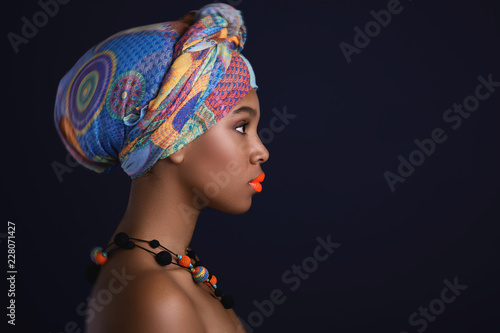 African woman with a colorful shawl on her head Poster Mural XXL