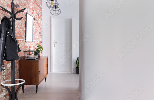 Cuadros en Lienzo Stylish apartment hall clothes hanger, cupboard and brick wall, real photo with