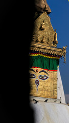 Buddha eyes from Swayambhunath Stupa looking from the corner of a wall