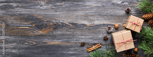 Christmas gifts in rustic stlye. Two gift boxes with cinnamon sticks, pine co...