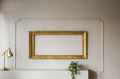 © Photographee.eu - Elegant, empty golden frame inside molding on a gray wall of a stylish living room interior with lamp and a plant. Real photo.