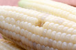 close up of waxy corn in wooden plate