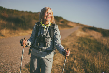 Senior woman is hiking in mountain. Active retirement.