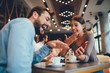 © djile - Young happy couple usinf smartphone in cafe