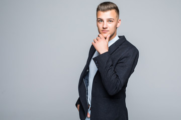 Cheerful businessman posing with hand on chin on white background