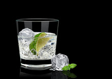 Vodka Lime, Mojito Or Gin Tonic  With Lime Wedge And Ice In Rocks Glass On Black Background Including Clipping Path