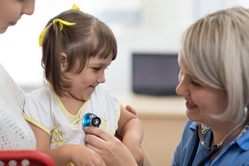 Wall Mural - Doctor examining baby with stethoscope in clinic. Baby health concept