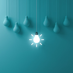 Fototapete - Think different concept One hanging glowing idea light bulb standing out from dim unlit bulbs on green pastel color wall background leadership and individuality creative idea concepts 3D rendering